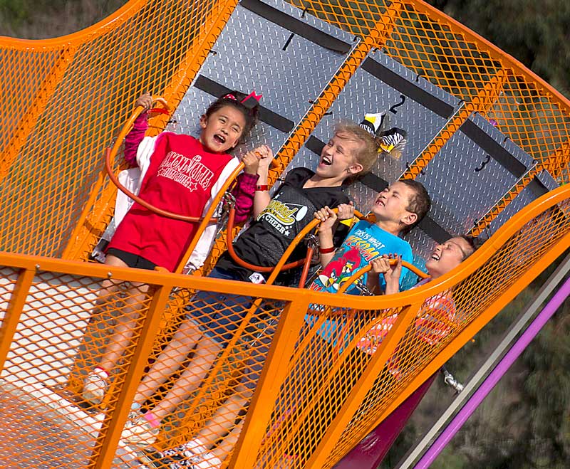Kayla Saiza, 8, Makayla Struble, 9, Jack Zepeda, 8, and Maya Zepeda, 10, enjoy the scat ride at Pantera Park in Diamond Bar, Calif. on Saturday, April 12, 2014. Carnival rides were brought in as part of an event to celebrate Diamond Bar's 25th anniversary.
